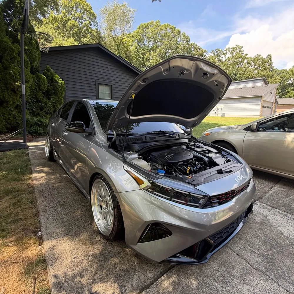 Kia Forte with hood open after engine bay detail